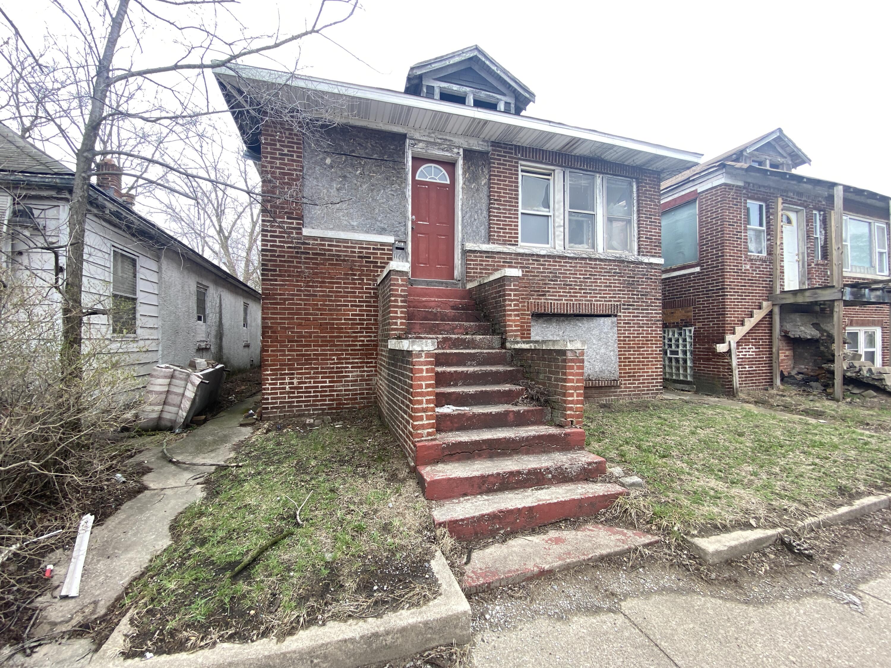 1161 Harrison Boulevard Gary, IN 46407 - Photo 1 of 3 a front view of a house with a yard
