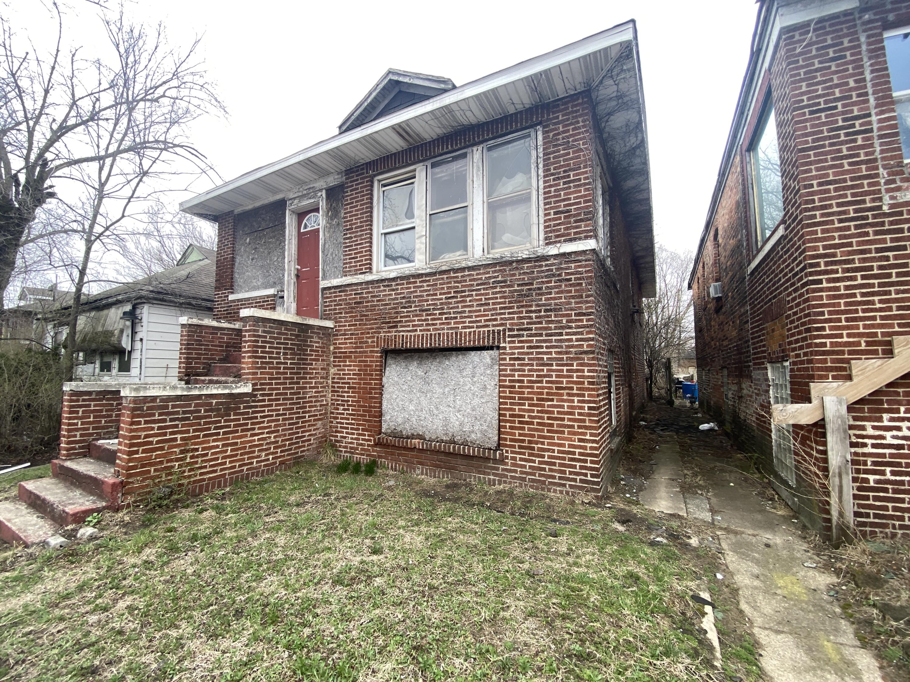 1161 Harrison Boulevard Gary, IN 46407 - Photo 2 of 3 a front view of a house with a garden