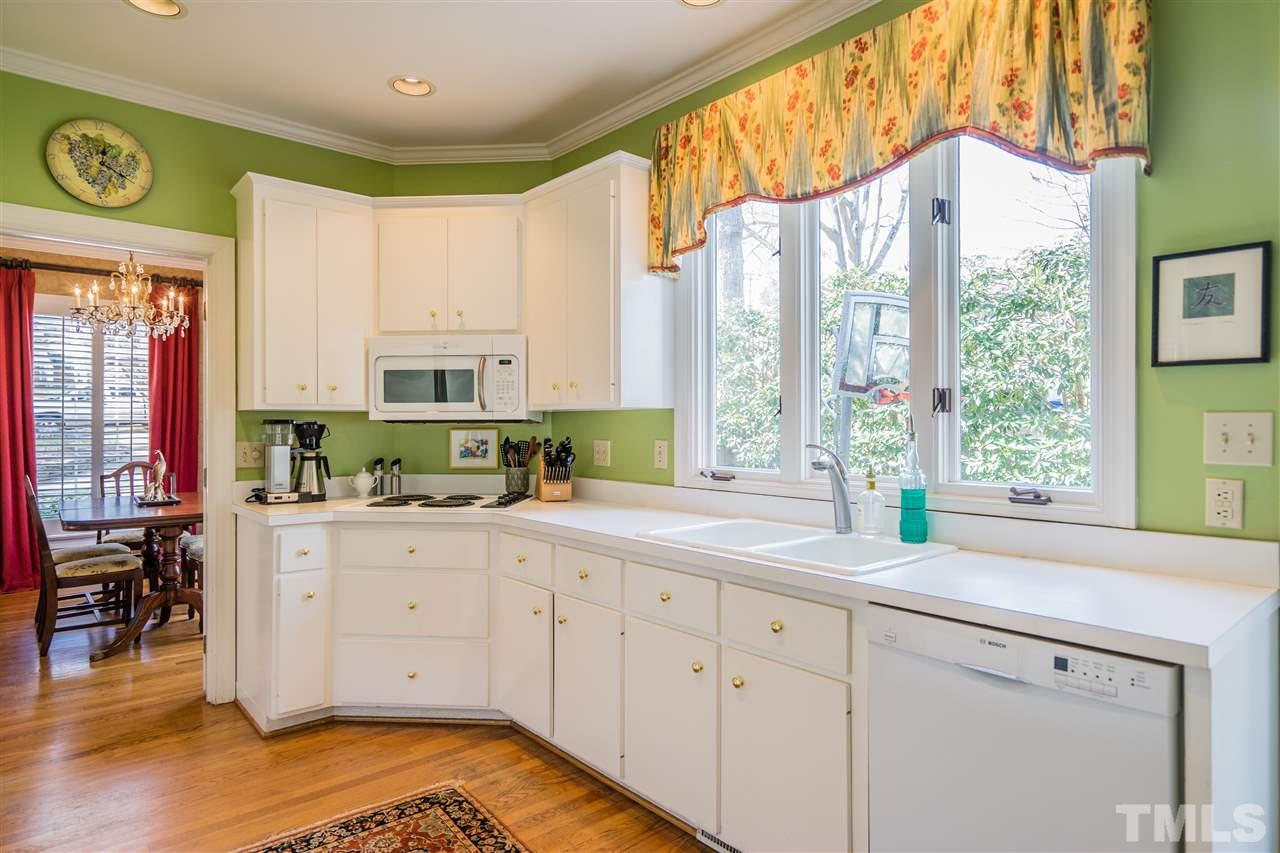 2808 Royster Street Raleigh, NC 27608 - Photo 11 of 25 a kitchen with sink cabinets and wooden floor