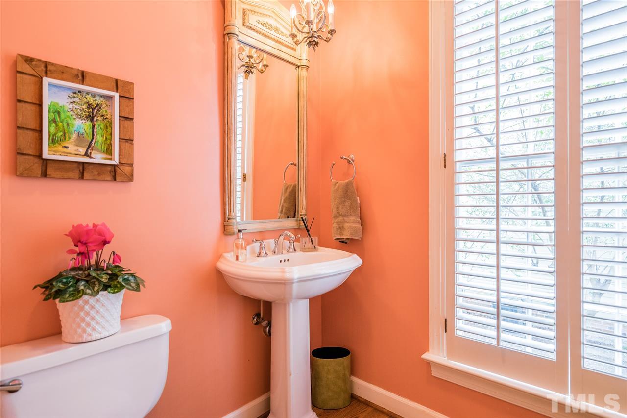 2808 Royster Street Raleigh, NC 27608 - Photo 13 of 25 a bathroom with a sink toilet and a mirror