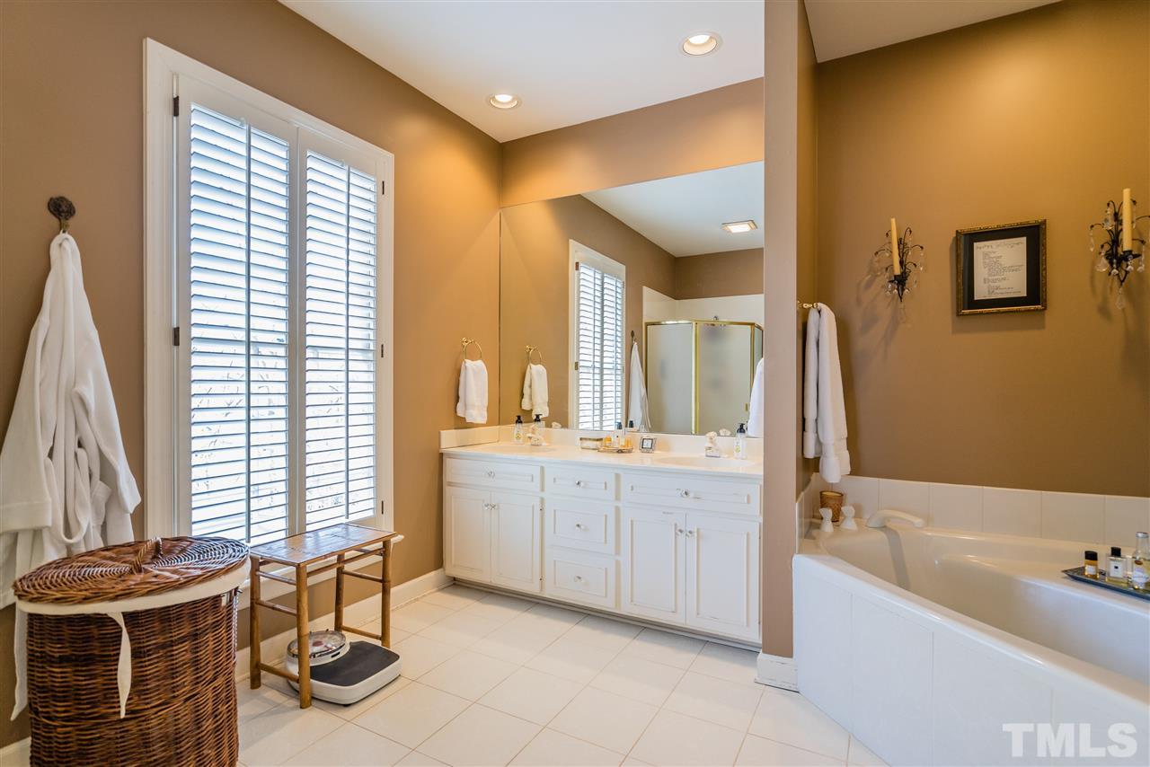 2808 Royster Street Raleigh, NC 27608 - Photo 15 of 25 a spacious bathroom with a bathtub sink and mirror