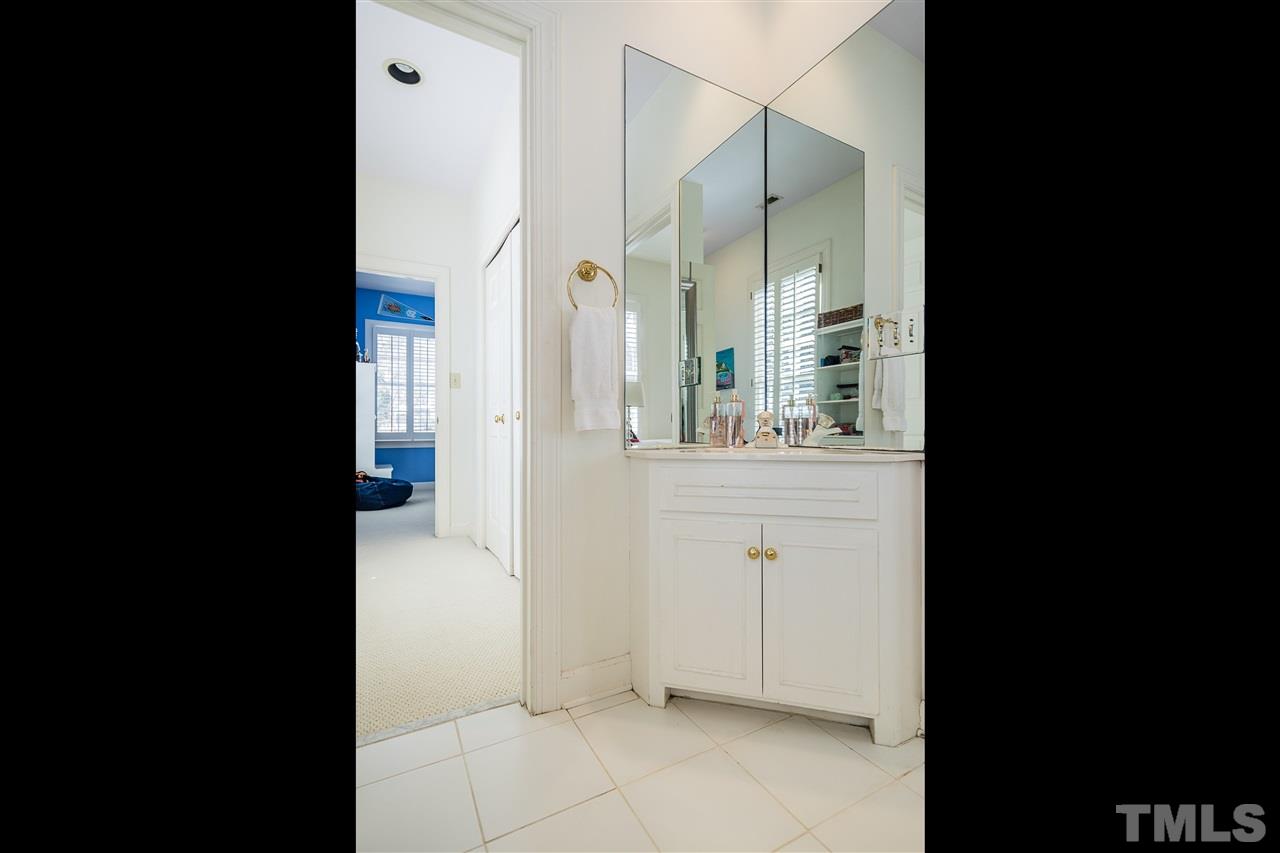 2808 Royster Street Raleigh, NC 27608 - Photo 18 of 25 a view of bathroom with a sink and mirror