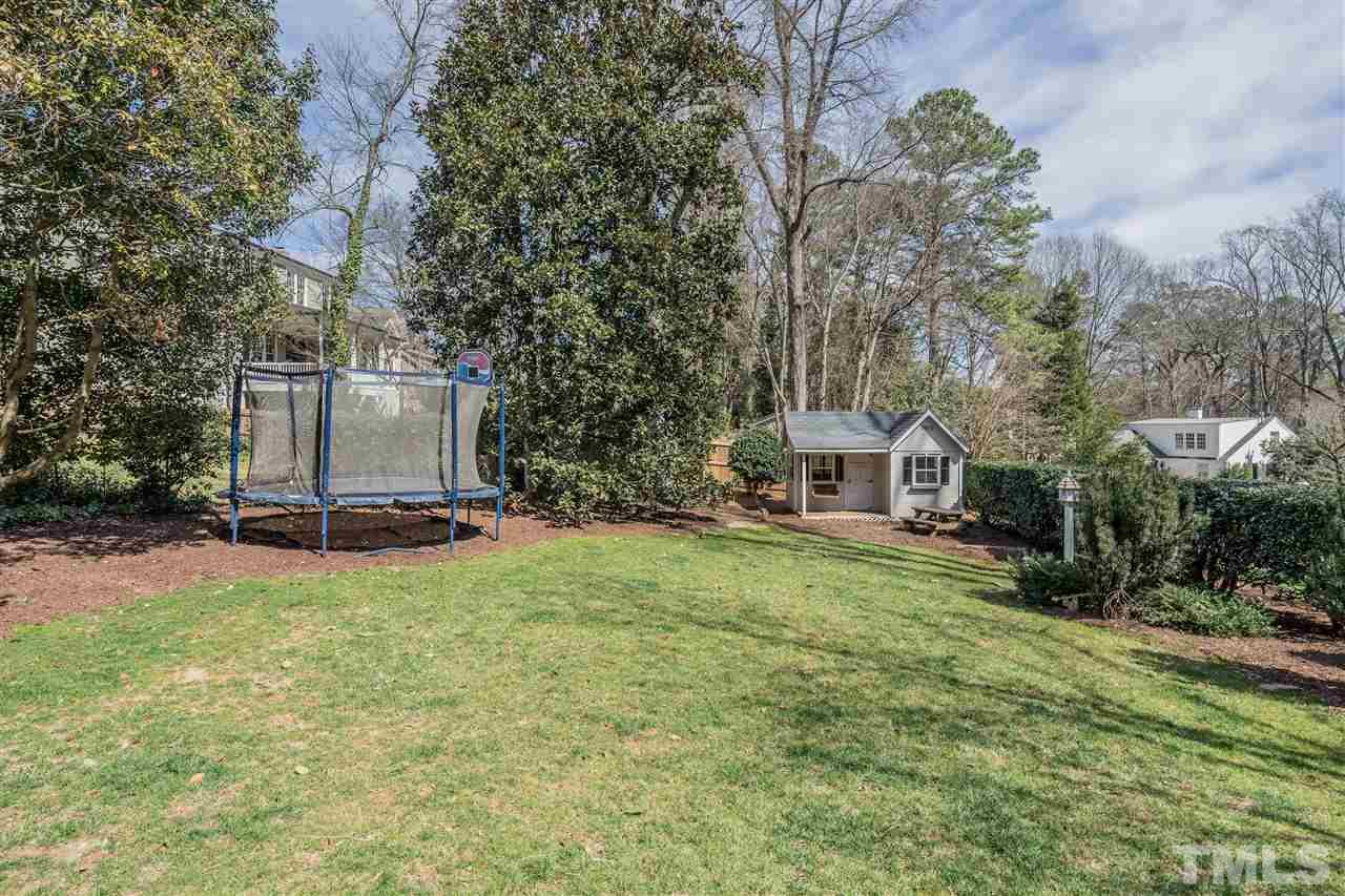 2808 Royster Street Raleigh, NC 27608 - Photo 23 of 25 a view of a big house with a big yard and large trees
