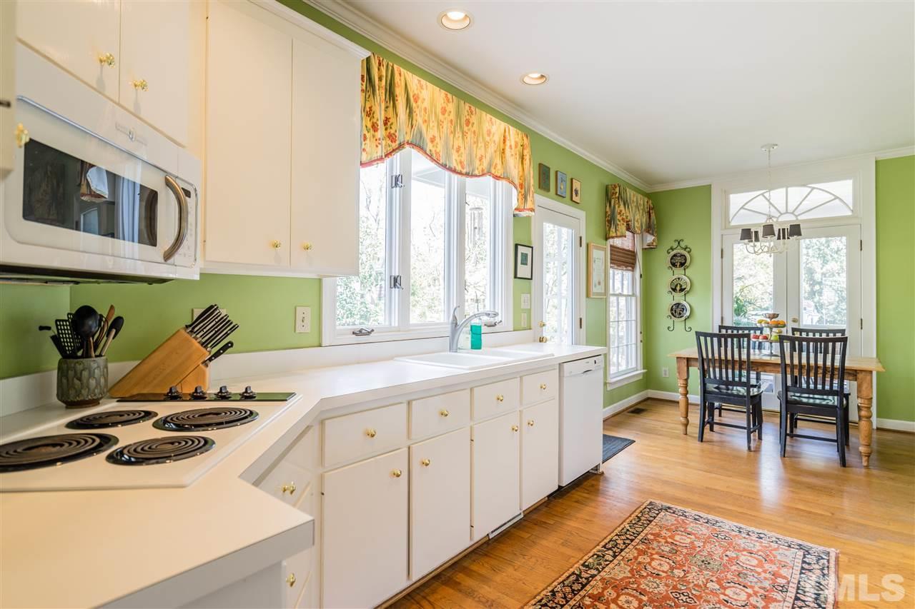 2808 Royster Street Raleigh, NC 27608 - Photo 10 of 25 a kitchen with a sink a stove and cabinets