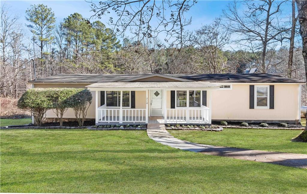 710 Seals Road Dallas, GA 30157 - Photo 1 of 1 a front view of a house with a garden