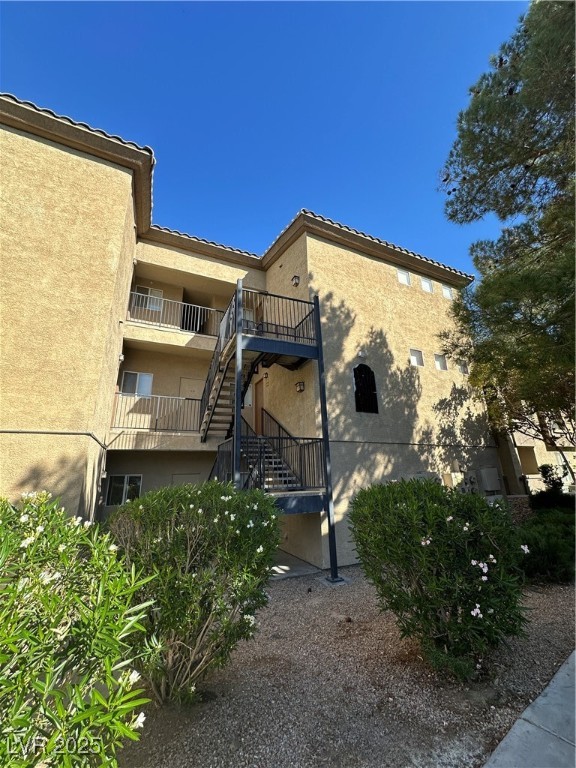 View of property featuring stairs
