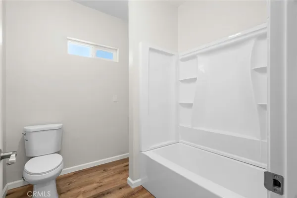 a bathroom with a toilet and a bathtub