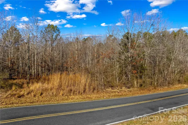 a view of backyard with wooden fence