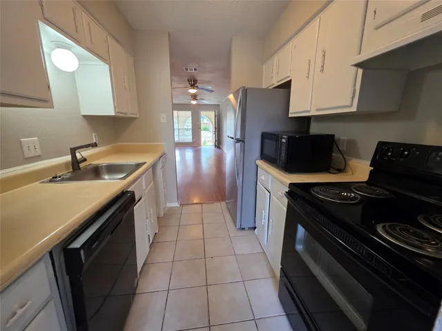 a kitchen that has a sink and a stove