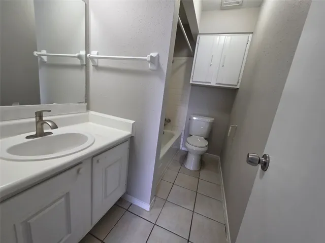 a bathroom with a sink toilet and a mirror