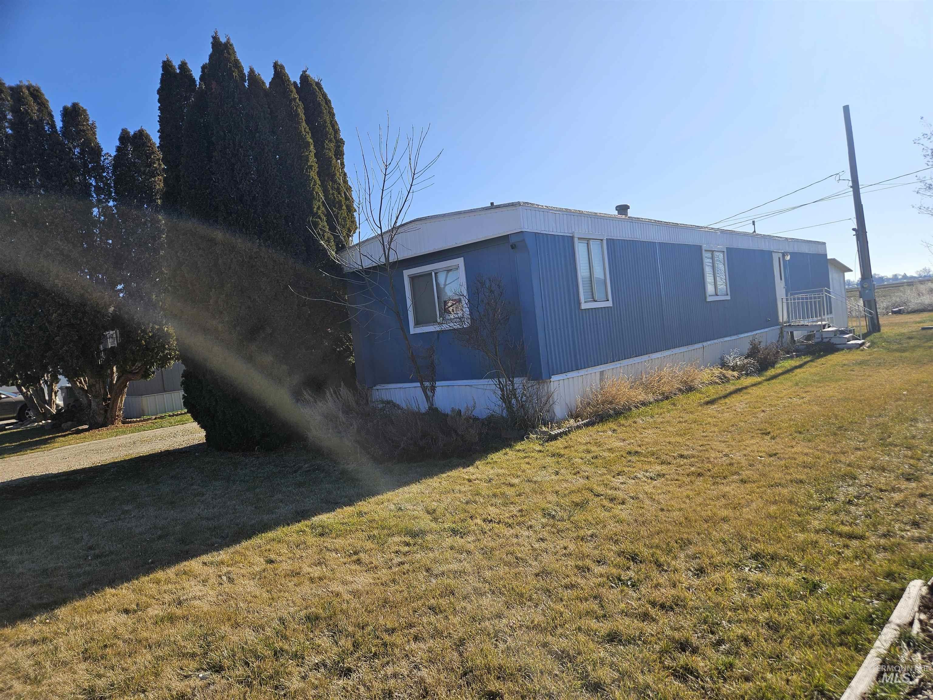 View of side of property with a lawn