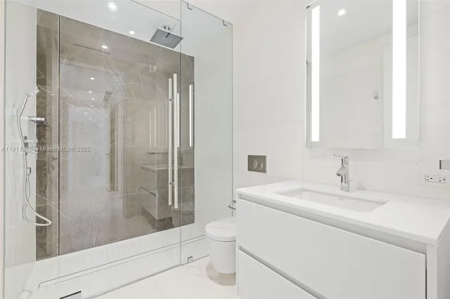 a bathroom with a shower sink and mirror
