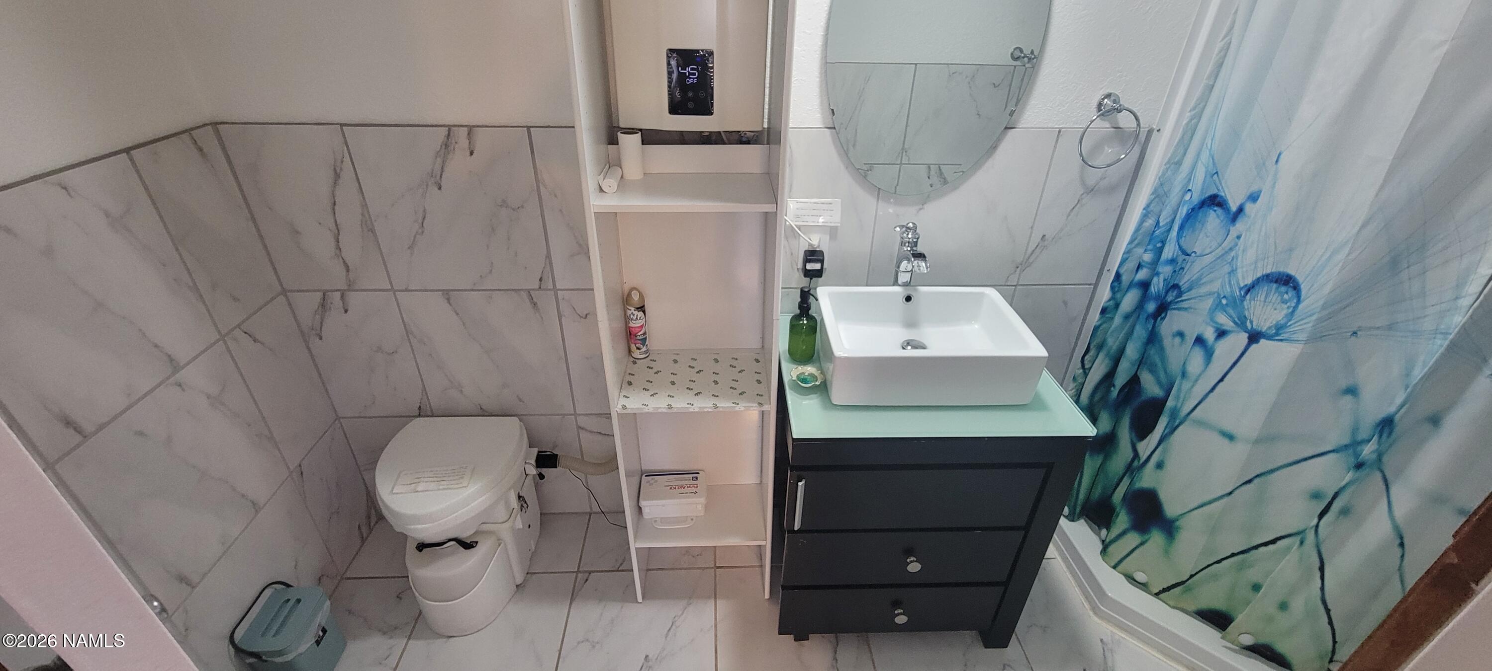 4650 Juniper Road Williams, AZ 86046 - Photo 12 of 28 a bathroom with a toilet and a sink