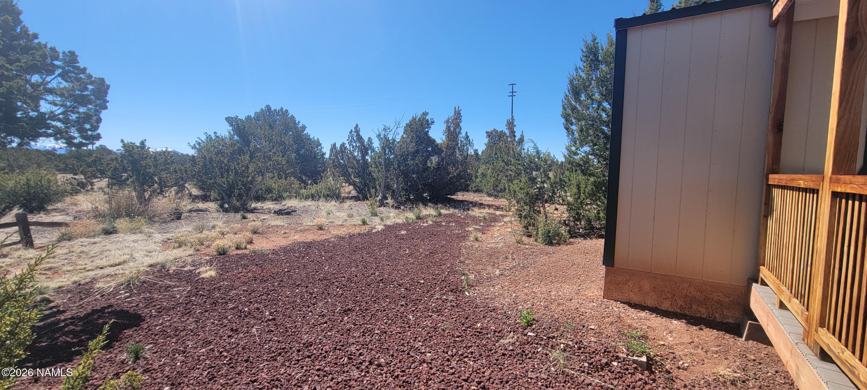4650 Juniper Road Williams, AZ 86046 - Photo 13 of 28 a view of a backyard with large trees