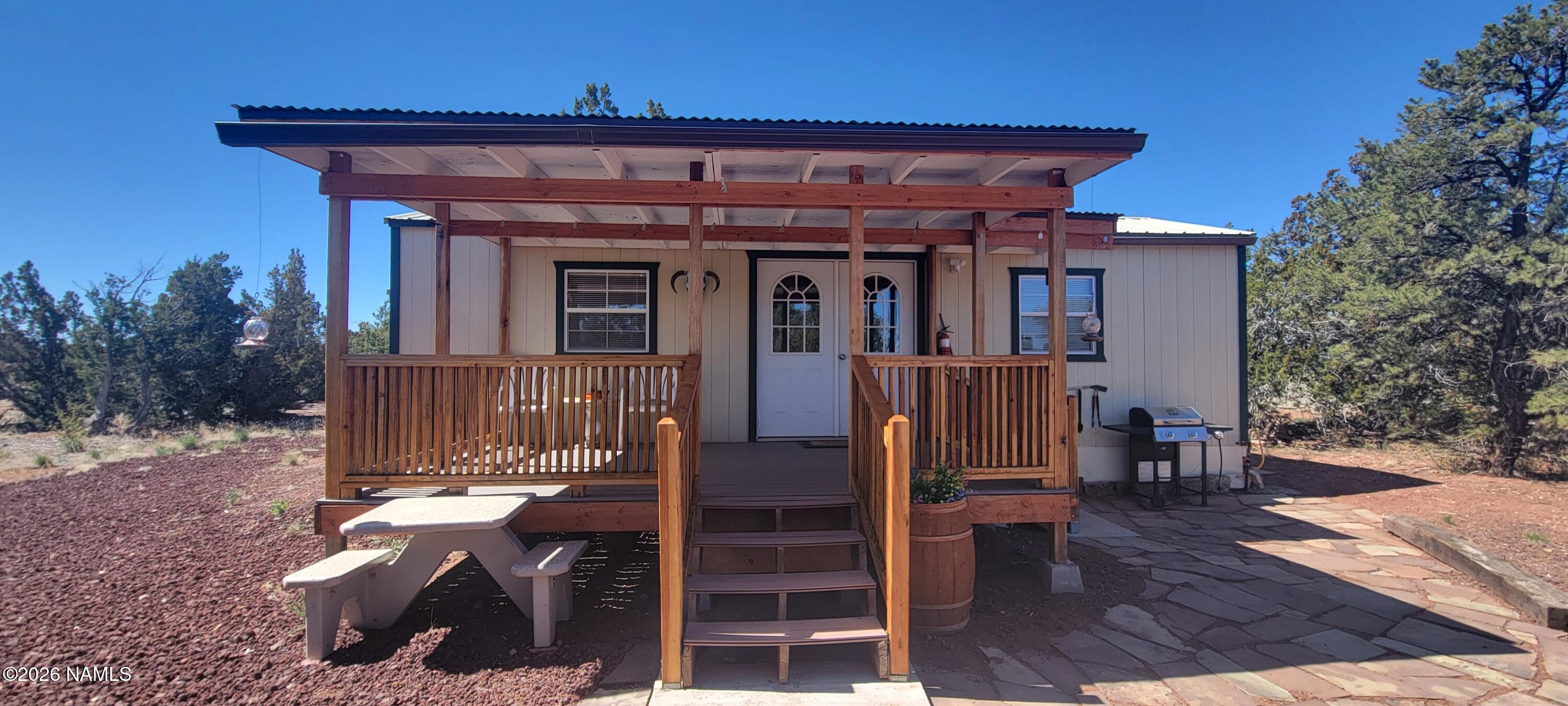 4650 Juniper Road Williams, AZ 86046 - Photo 15 of 28 a view of a house with wooden deck and furniture