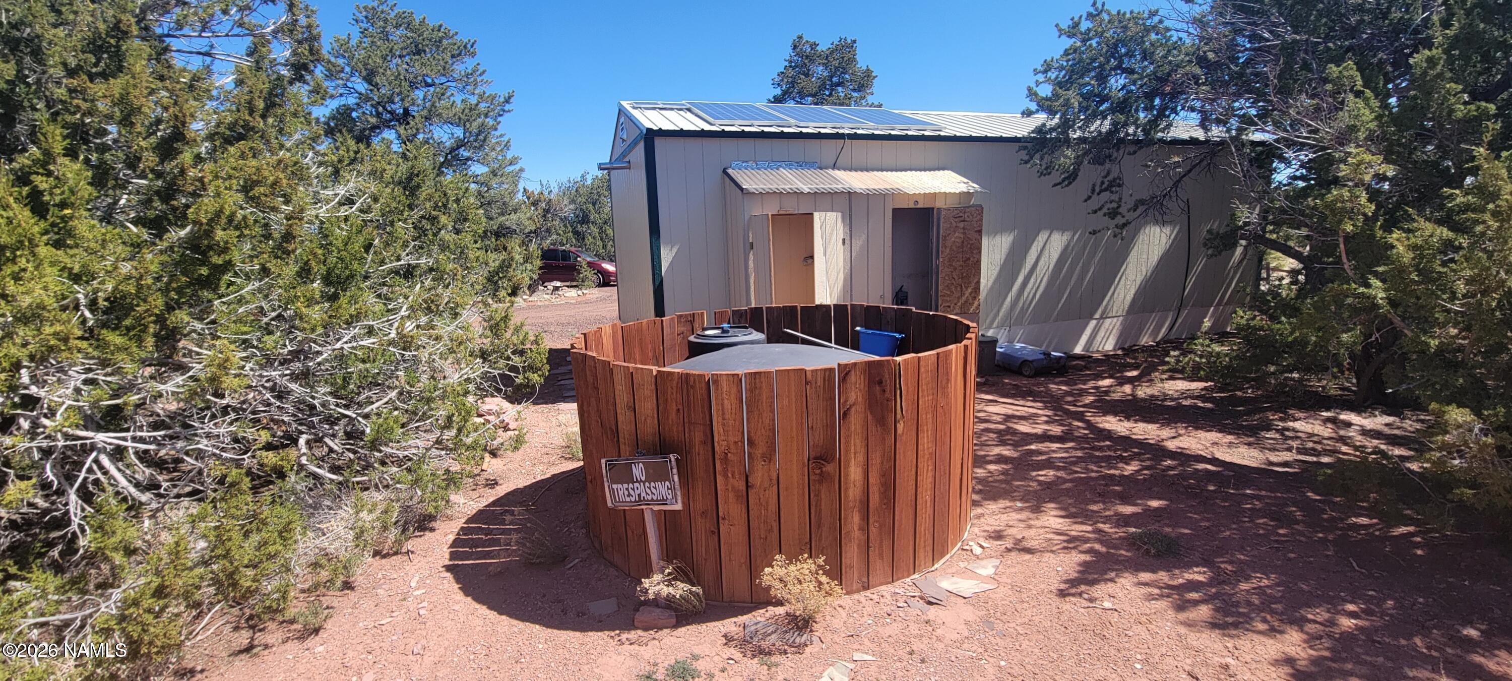 4650 Juniper Road Williams, AZ 86046 - Photo 20 of 28 a view of a house with a small yard and plants