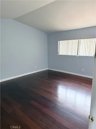 a view of an empty room and wooden floor