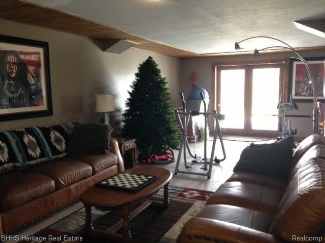 7546 West Sherwood Road Fowlerville, MI 48836 - Photo 25 of 32 Finished area walk out next to pool room and bar