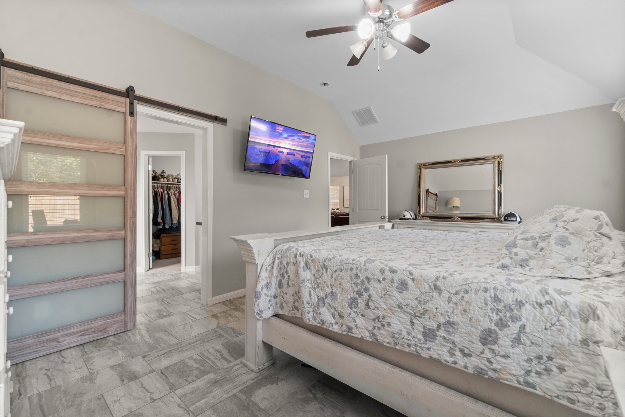 28987 Birch Green Way Spring, TX 77386 - Photo 18 of 32 a bedroom with a bed and a chandelier