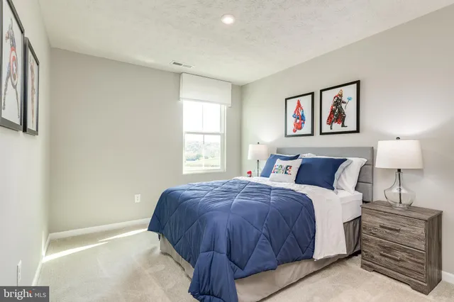 a spacious bedroom with a bed and a window