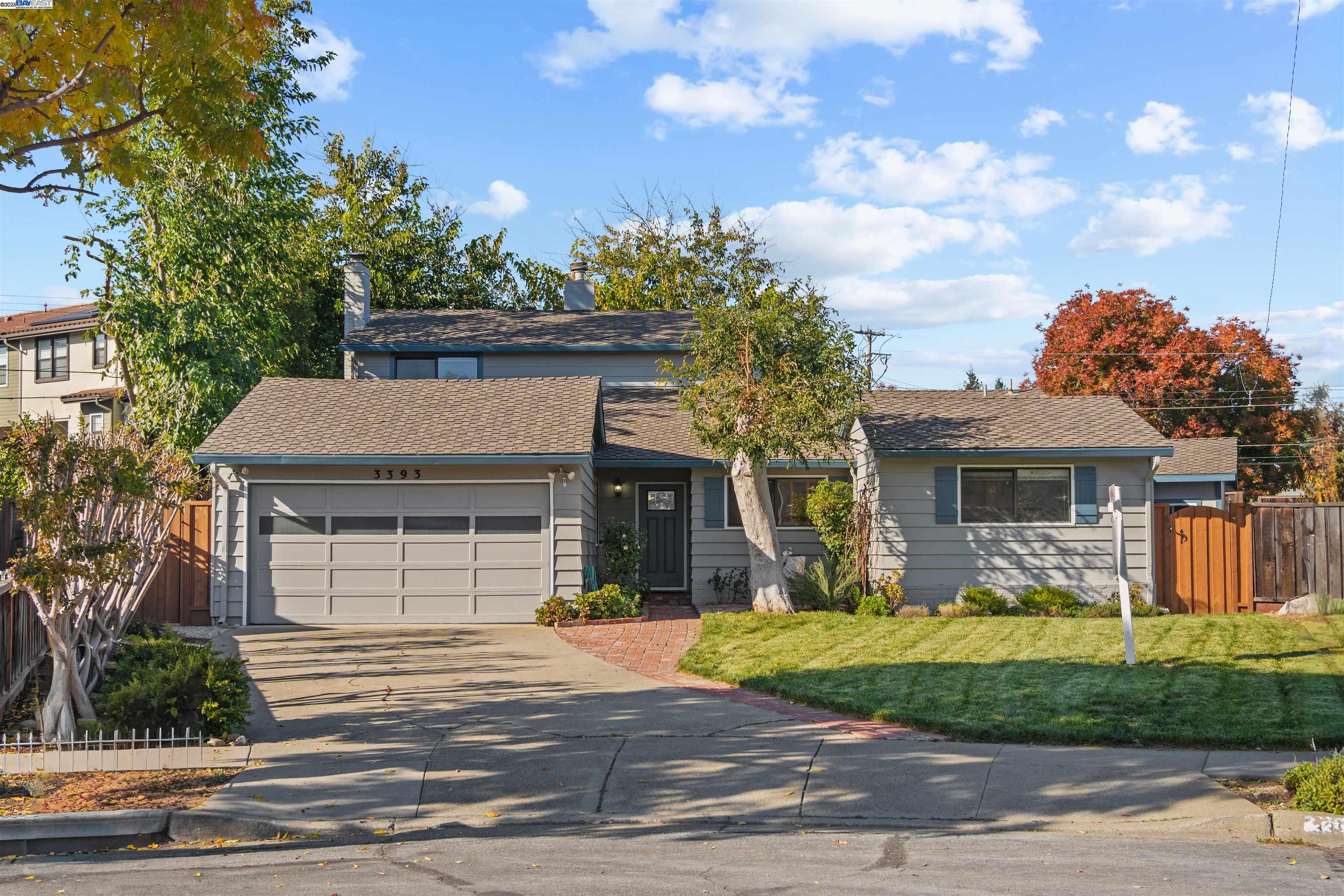 3393 Sutton Loop Fremont, CA 94536 - Photo 1 of 47 a front view of a house with a garden