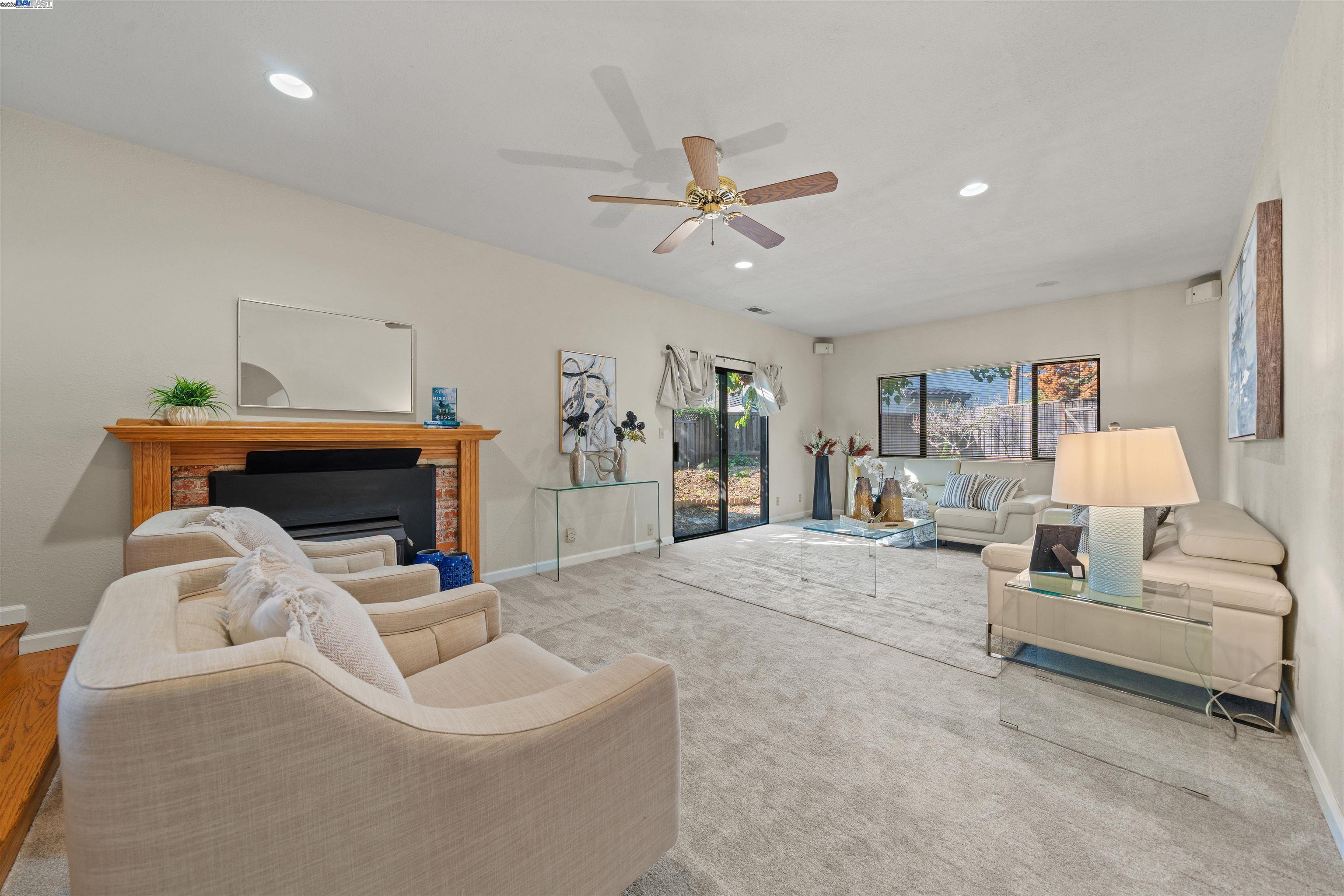 3393 Sutton Loop Fremont, CA 94536 - Photo 12 of 47 a living room with furniture and a chandelier