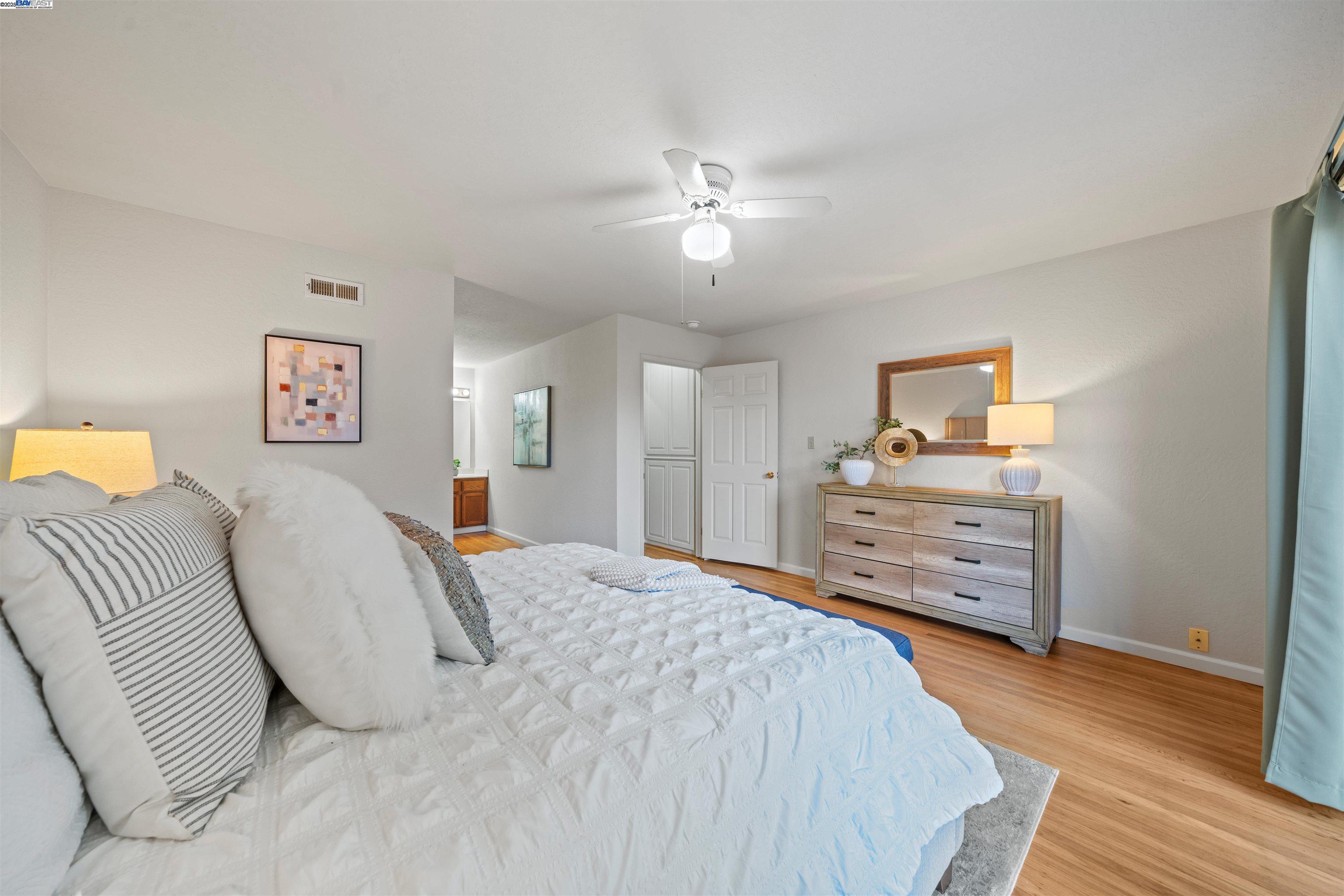 3393 Sutton Loop Fremont, CA 94536 - Photo 16 of 47 a bedroom with a bed and wooden floor