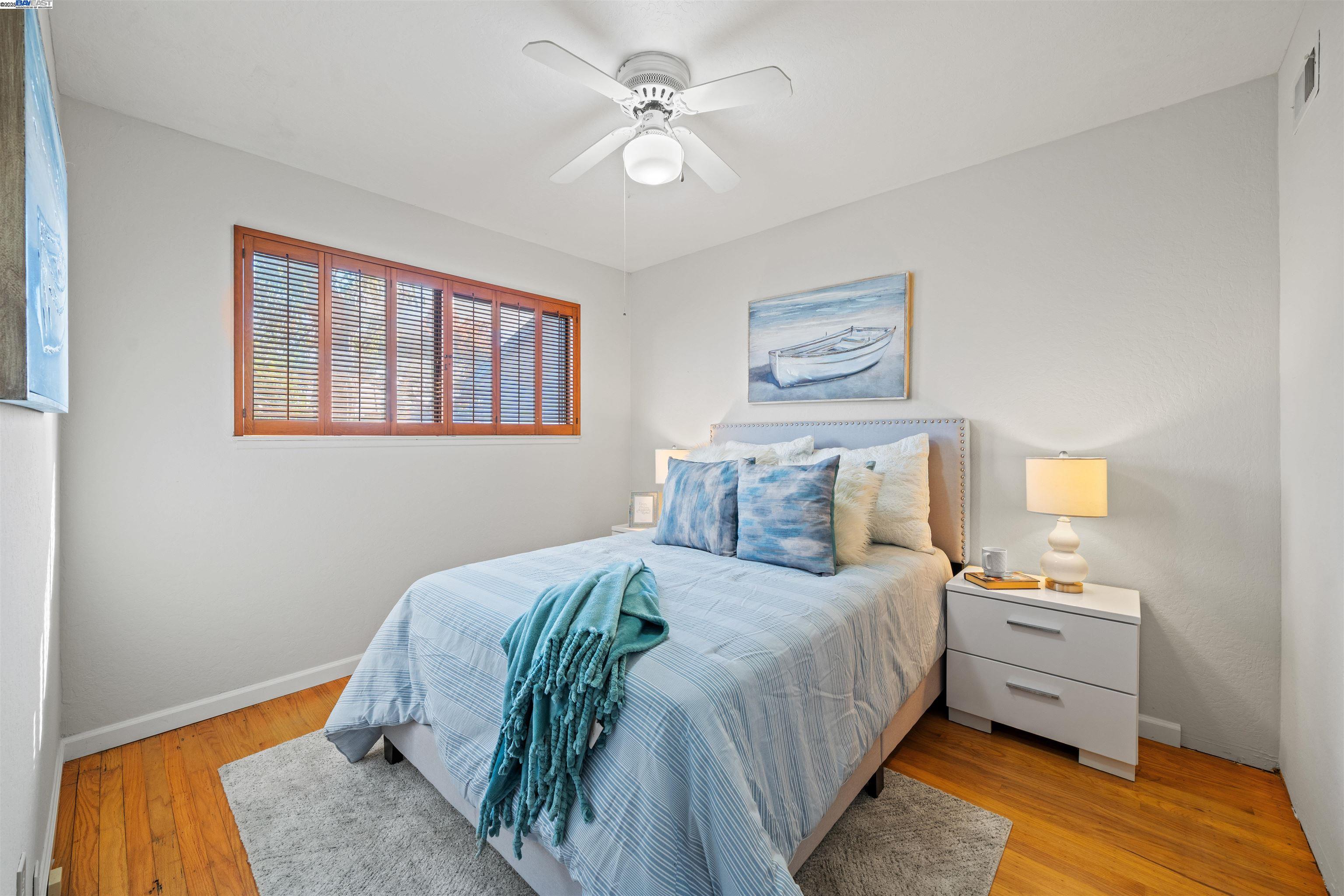 3393 Sutton Loop Fremont, CA 94536 - Photo 20 of 47 a bedroom with a large bed and a chandelier