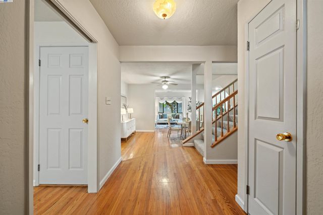 a view of a hallway view with wooden floor and staircase