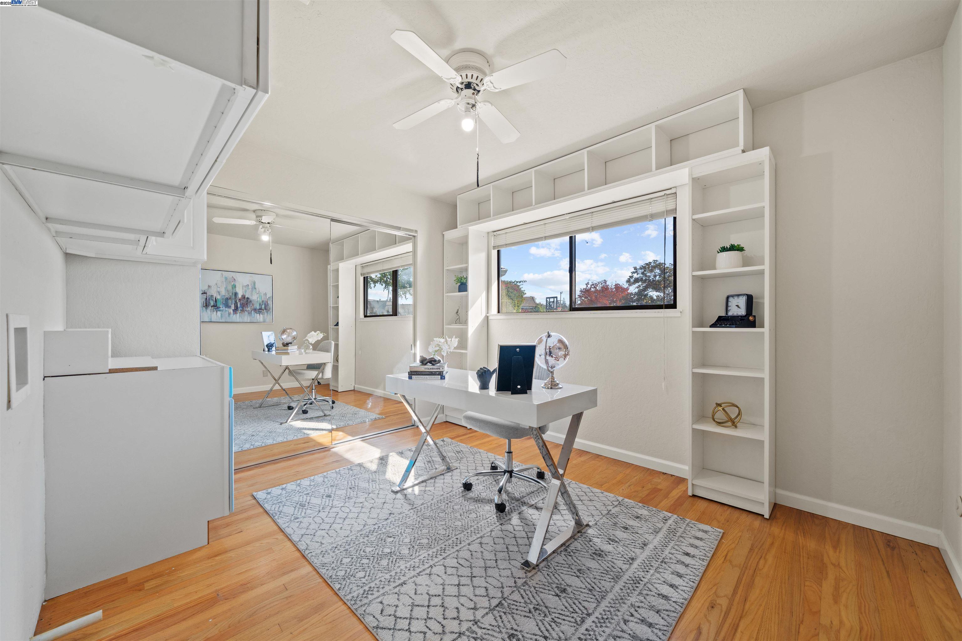 3393 Sutton Loop Fremont, CA 94536 - Photo 23 of 47 a work room with furniture a large window and wooden floor