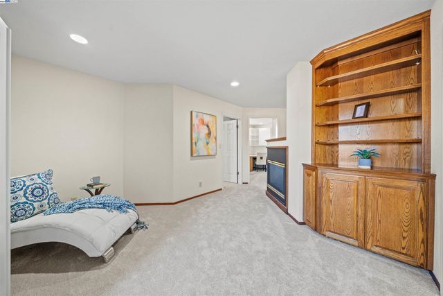 a living room with stainless steel appliances furniture and a window