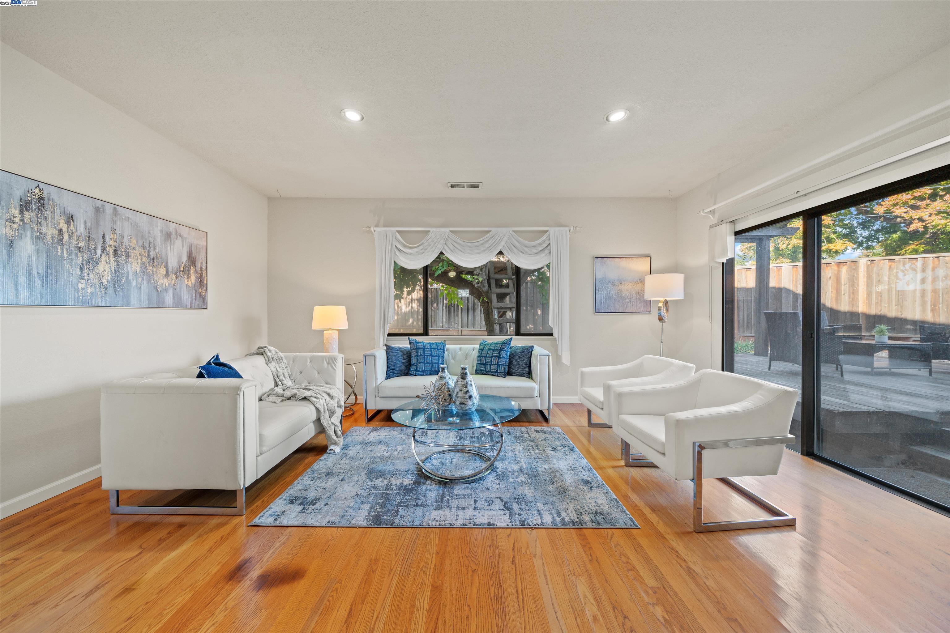 3393 Sutton Loop Fremont, CA 94536 - Photo 7 of 47 a living room with furniture and a wooden floor