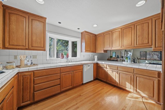 a kitchen with sink cabinets and window