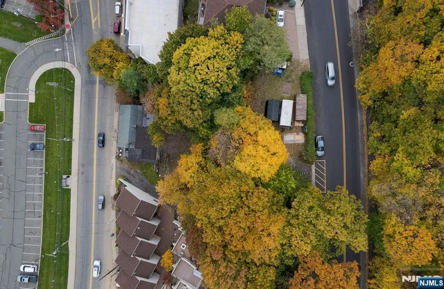 an aerial view of a house with a yard and lake view