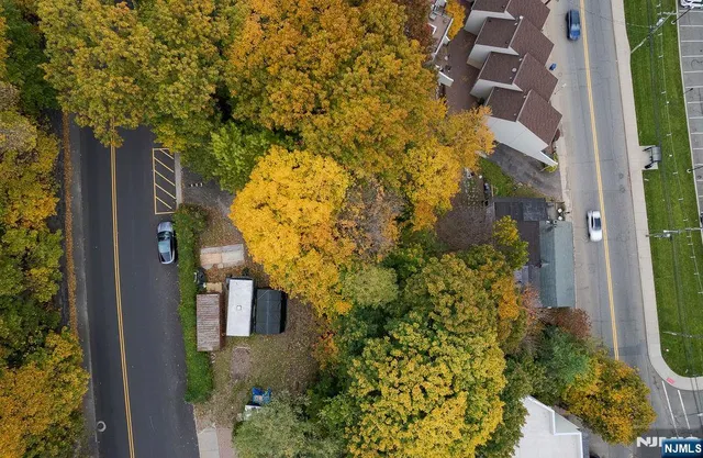 an aerial view of a house with a yard and garden