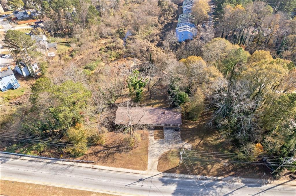 1018 South Hairston Road Stone Mountain, GA 30088 - Photo 1 of 3 a backyard of a house with large trees