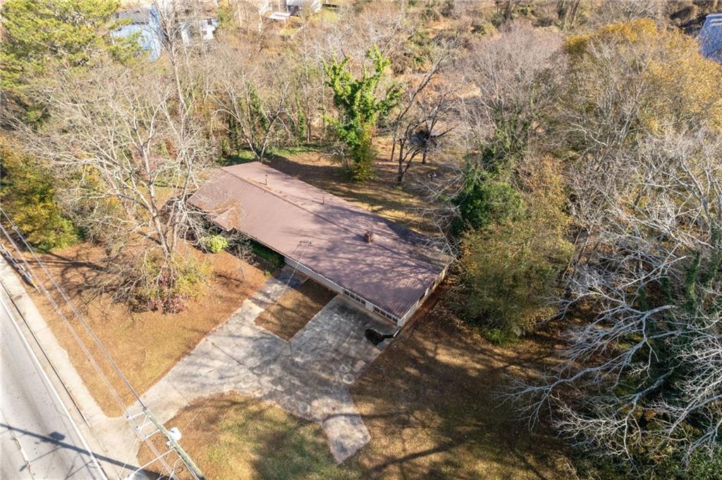 1018 South Hairston Road Stone Mountain, GA 30088 - Photo 2 of 3 a view of a yard with plants and large trees