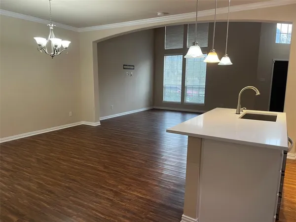 a view of a room with wooden floor and chandelier