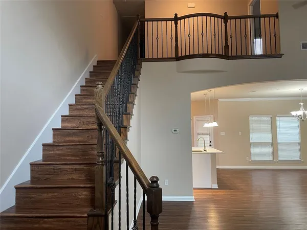 a view of entryway and hall with wooden floor