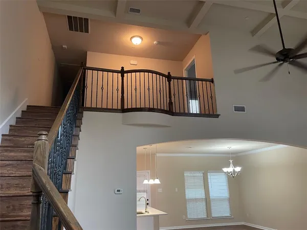 a view of staircase with railing and white walls