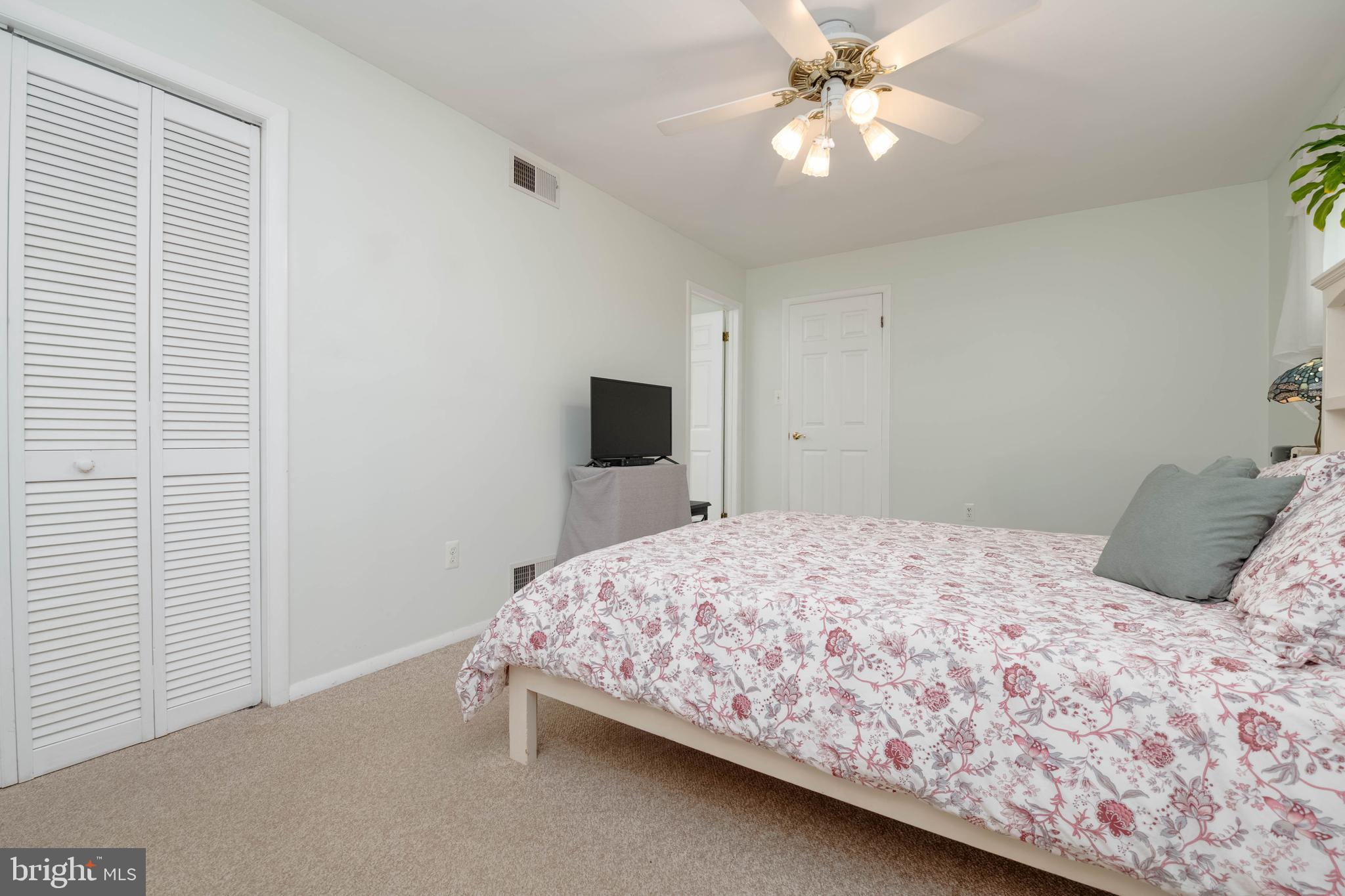8600 Saddler Road Parkville, MD 21234 - Photo 11 of 39 a bedroom with a bed and a chandelier