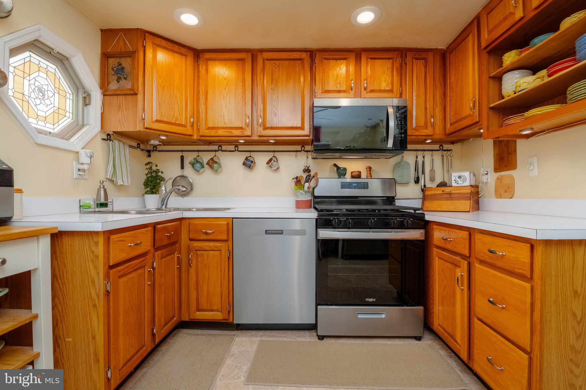 8600 Saddler Road Parkville, MD 21234 - Photo 19 of 39 a kitchen with stainless steel appliances a stove a sink and a microwave