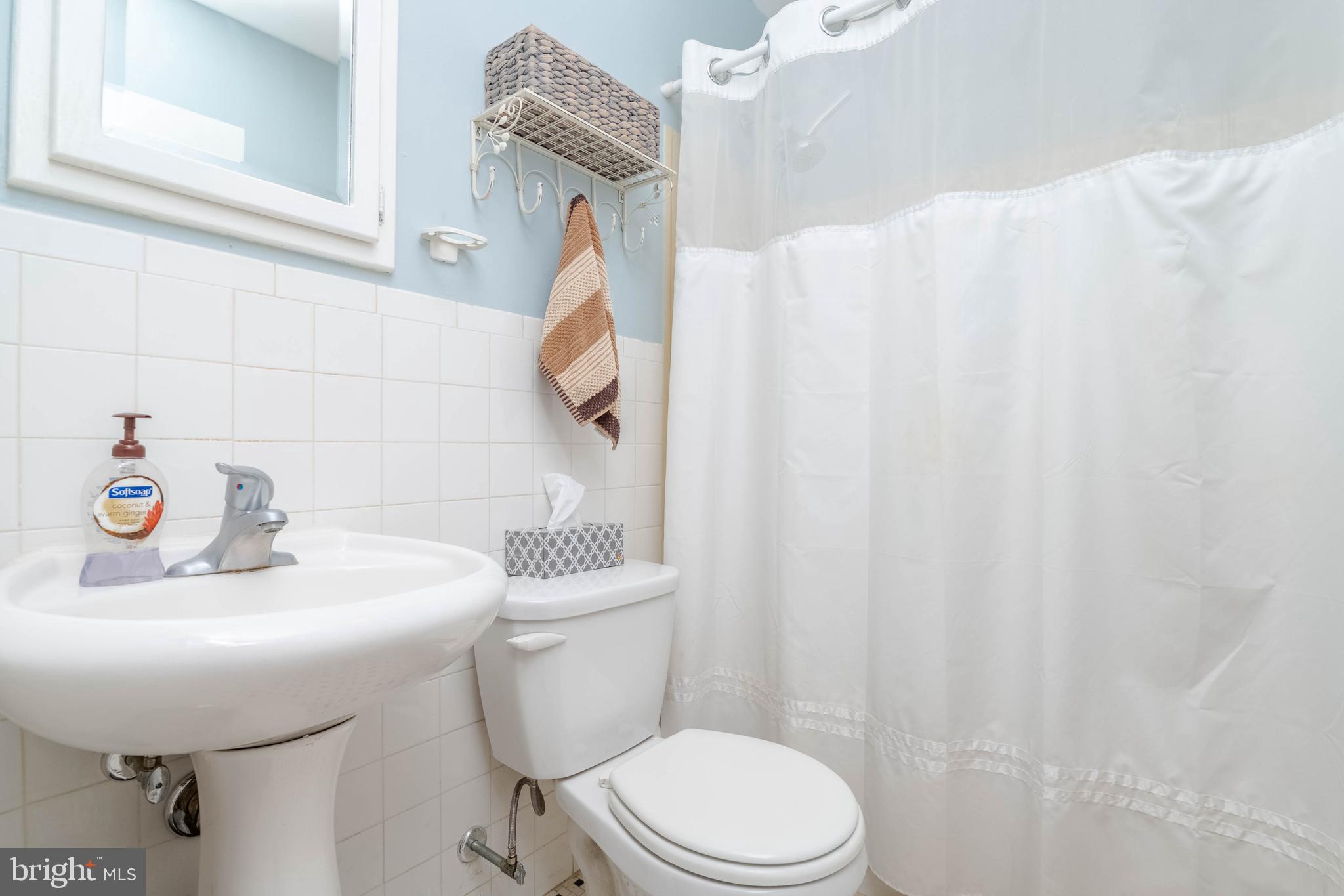 8600 Saddler Road Parkville, MD 21234 - Photo 29 of 39 a bathroom with a sink a toilet and shower curtain