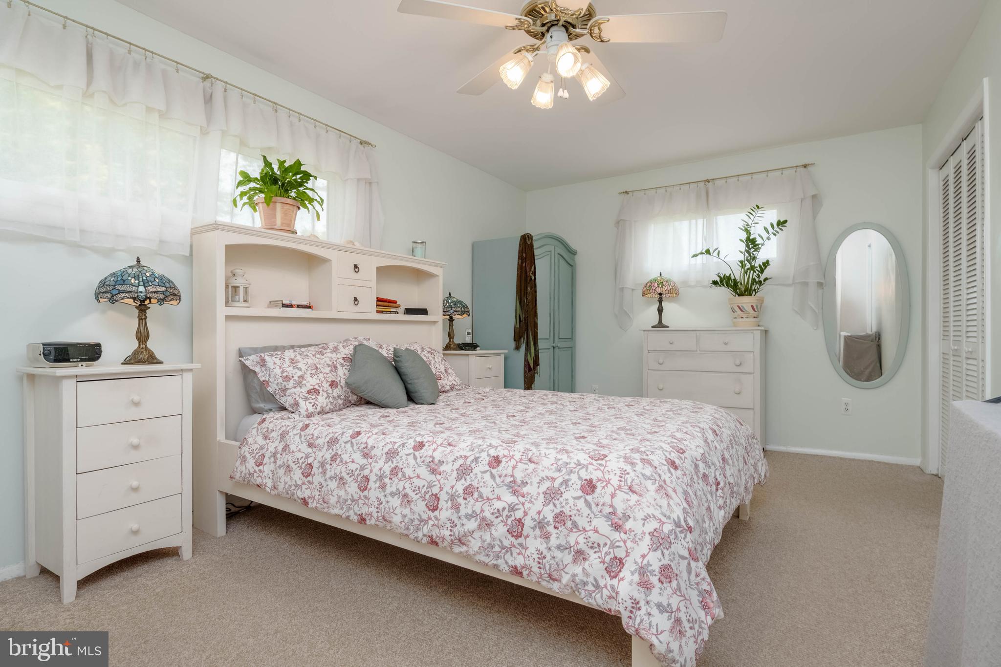 8600 Saddler Road Parkville, MD 21234 - Photo 9 of 39 a bedroom with a bed and a chandelier