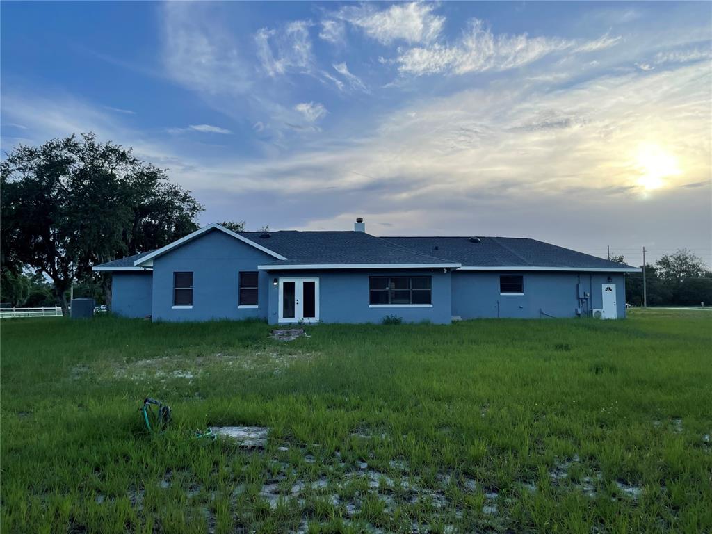 755 South Narcoossee Road St. Cloud, FL 34771 - Photo 2 of 44 a view of a yard in front of a house with large trees