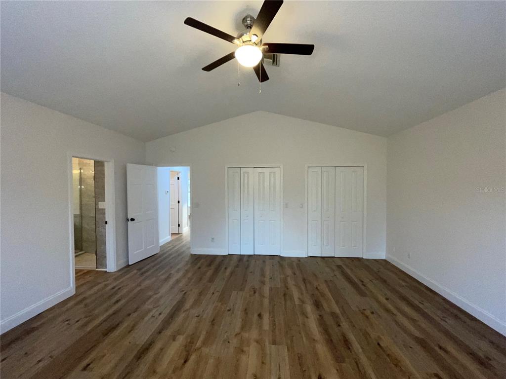 755 South Narcoossee Road St. Cloud, FL 34771 - Photo 21 of 44 a view of room with hardwood floor and a ceiling fan