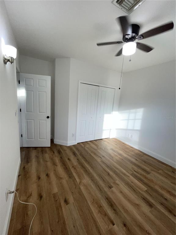 755 South Narcoossee Road St. Cloud, FL 34771 - Photo 23 of 44 a view of empty room with wooden floor and fan