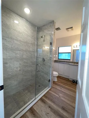 a bathroom with a shower and a toilet