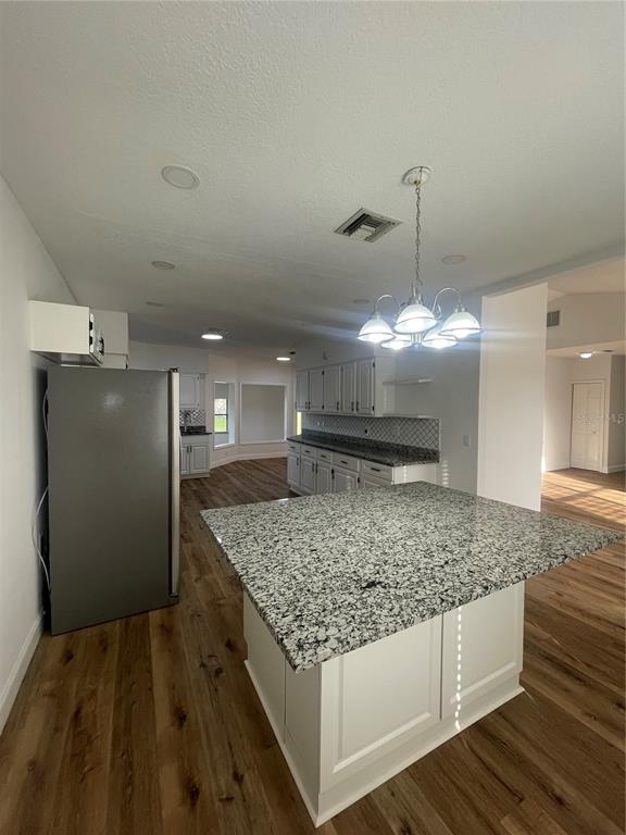 755 South Narcoossee Road St. Cloud, FL 34771 - Photo 37 of 44 a kitchen with stainless steel appliances granite countertop a sink and a refrigerator