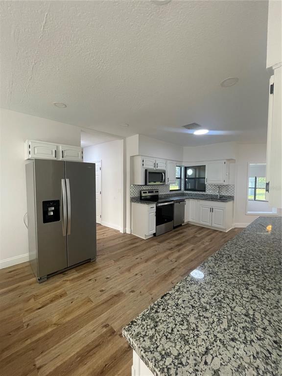 755 South Narcoossee Road St. Cloud, FL 34771 - Photo 38 of 44 a view of kitchen with wooden floor